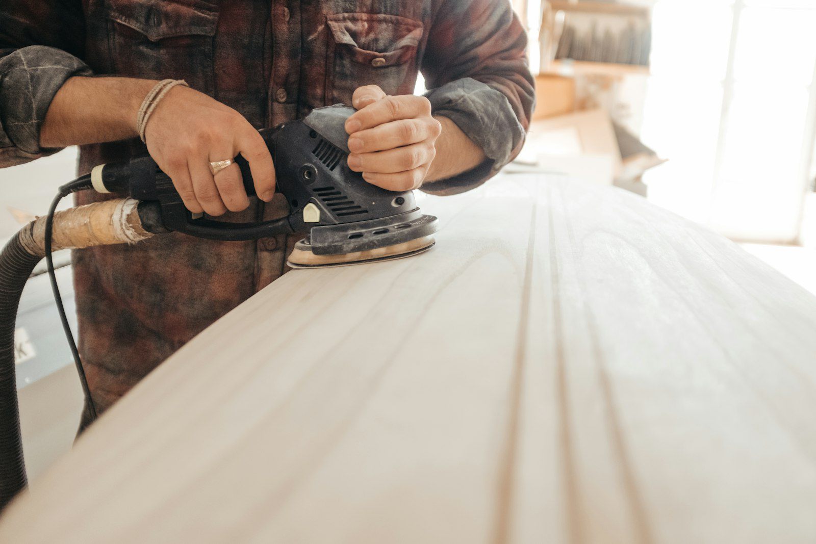 Sanding a pale timber surface