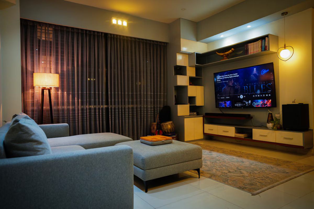 Living room with built-in shelving and warm lamp light